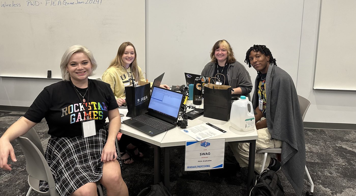 Lilly with the SWAG team around laptops at a game jam.